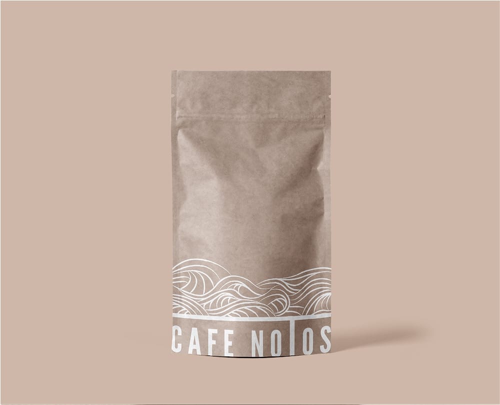 A brown resealable coffee bag with white wave designs and partial text CAFE NOTOS visible at the bottom, set against a beige background.
