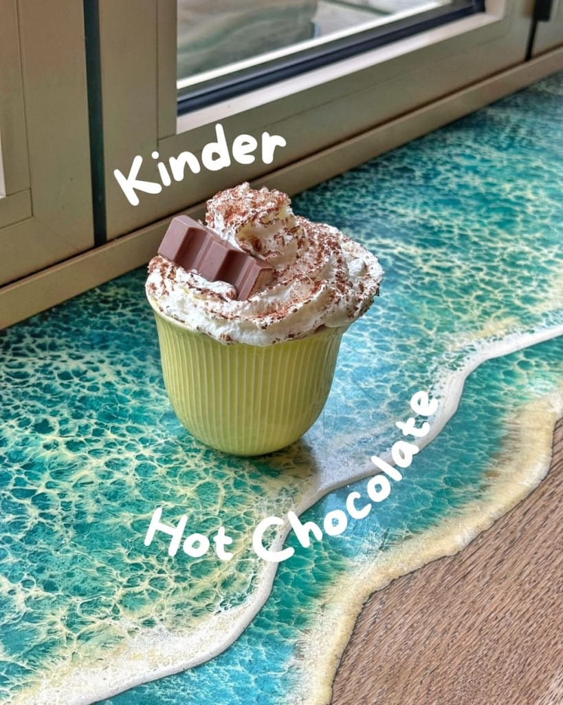 A kinder flavoured hot chocolate with whipped cream and chocolate dust.