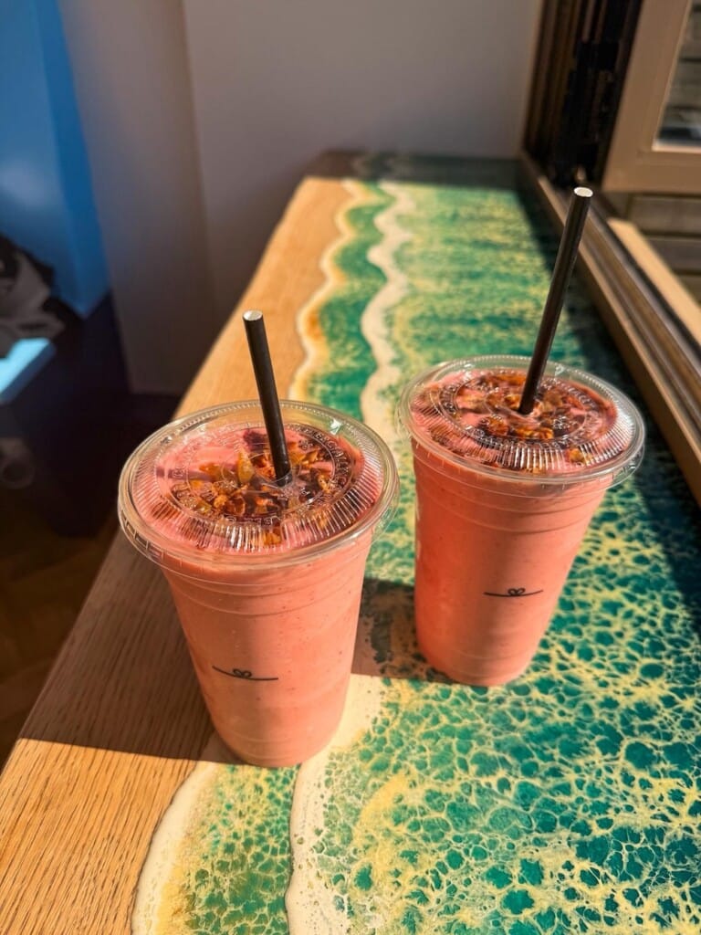 Pink coloured smoothie drink in takeaway cup