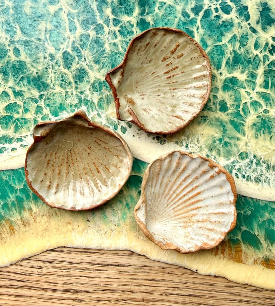 Ceramic shell dishes with a white and brown speckled glaze.